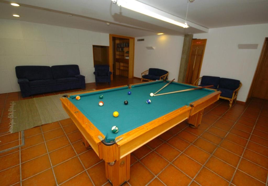 a room with a pool table with balls on it at Hotel Apartamento Porto Covo in Porto Covo