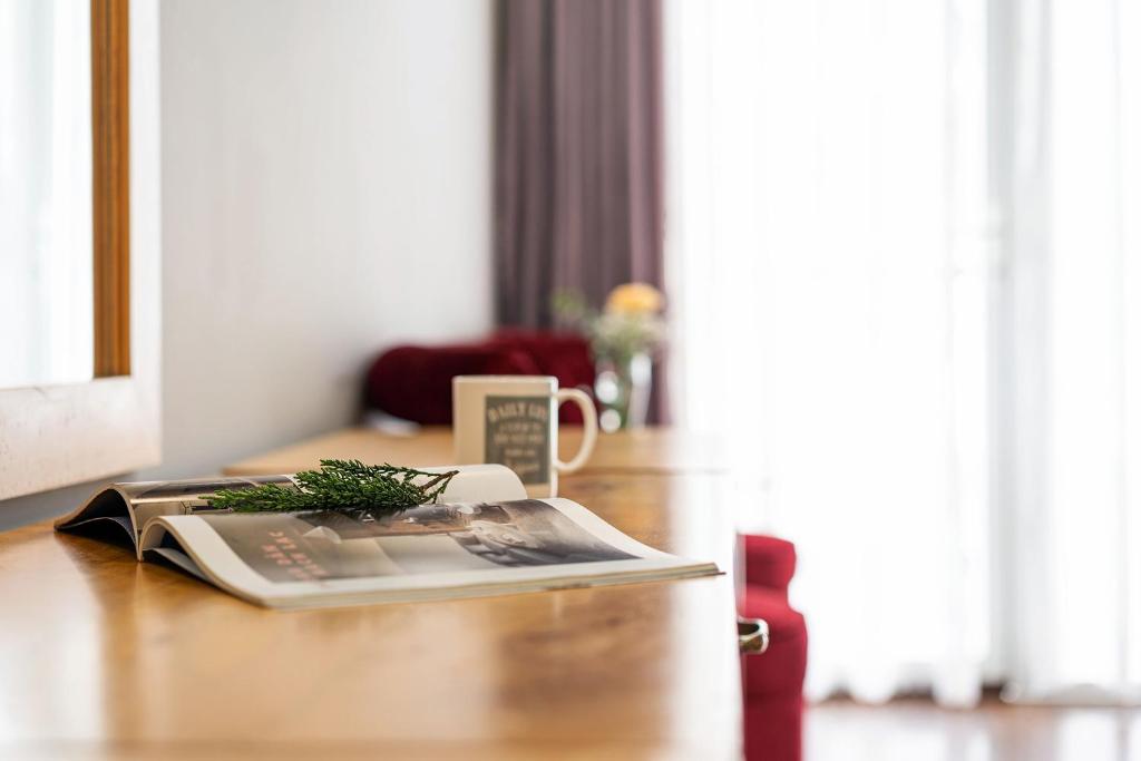 a book on a desk with a magazine on it at Dalat Wind Hotel in Da Lat