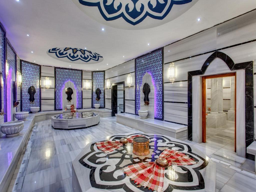 a hotel lobby with a tub and a table at Sherwood Exclusive Kemer - Kids Concept in Kemer