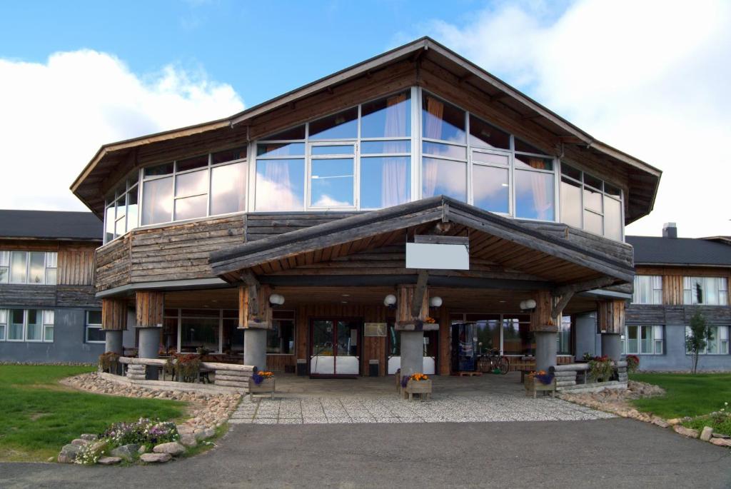 a large building with glass windows on the front at Lapland Hotels Ylläskaltio in Äkäslompolo