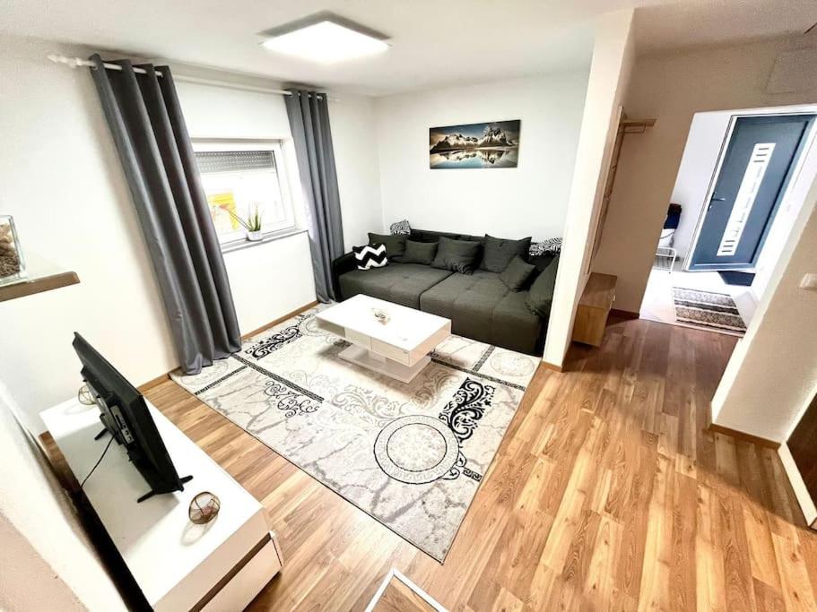 a living room with a couch and a table at AB Apartment Moderne Zweizimmerwohnung in Villach