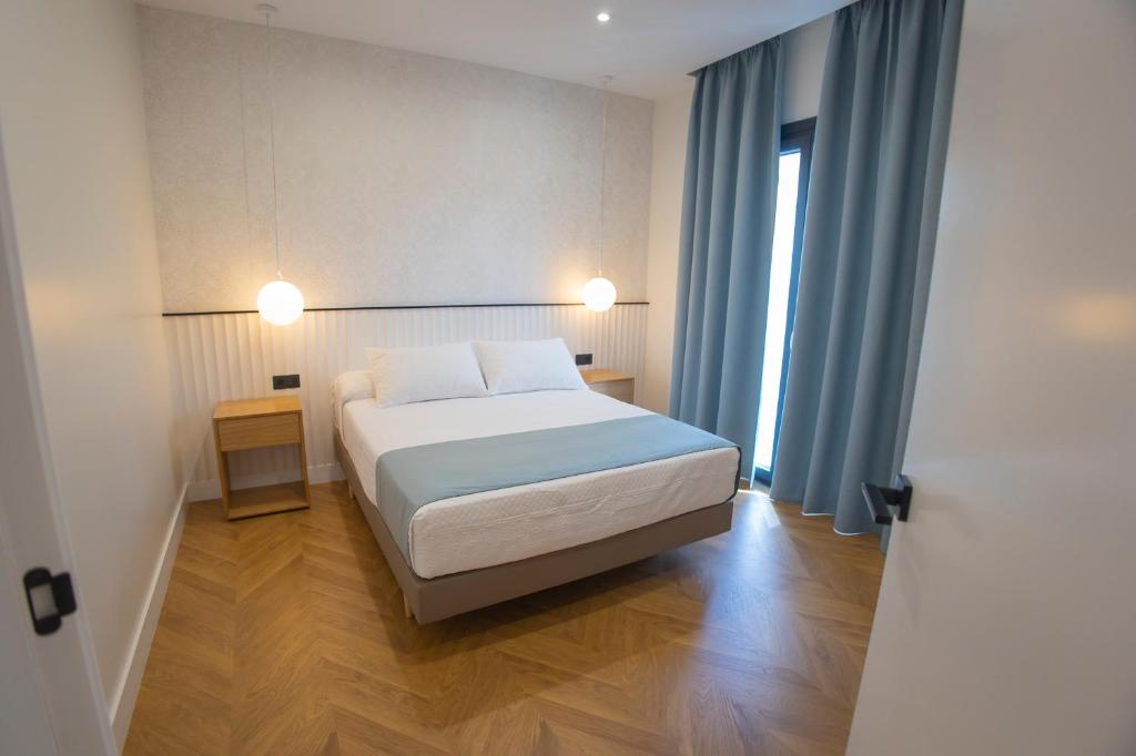 Posteľ alebo postele v izbe v ubytovaní OIKOS APARTAMENTOS TURÍSTICOS