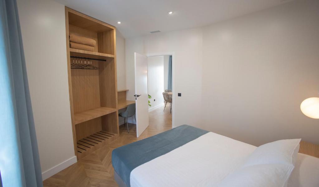 Posteľ alebo postele v izbe v ubytovaní OIKOS APARTAMENTOS TURÍSTICOS
