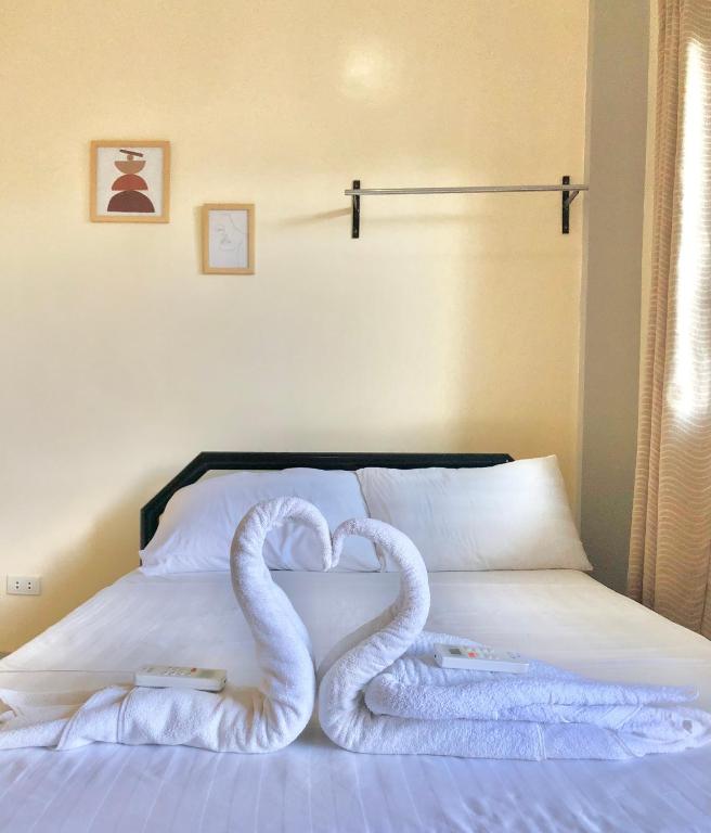 Postel nebo postele na pokoji v ubytování Hanna's Inn, El Nido