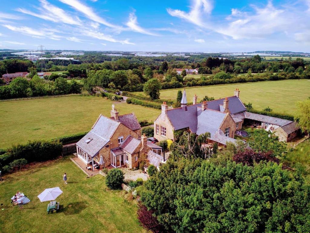 an aerial view of a large house in a field at Unique Countryside Cottage close to Sunderland in Houghton le Spring