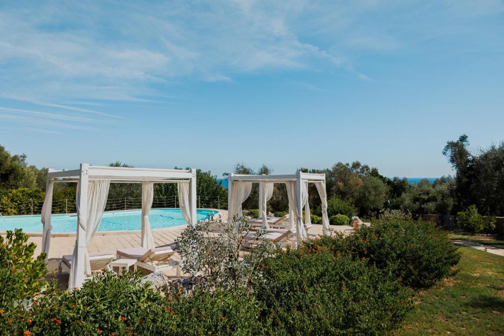 a group of chairs and a pool in a yard at Marenea Suite Hotel - CDSHotels in Marittima