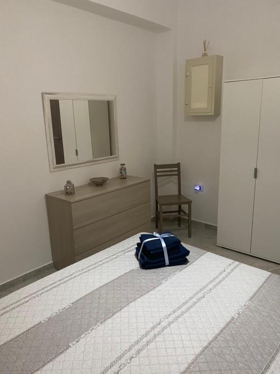 un dormitorio con una bolsa azul sentada en una cama en La Conchiglia, en Torre Ovo