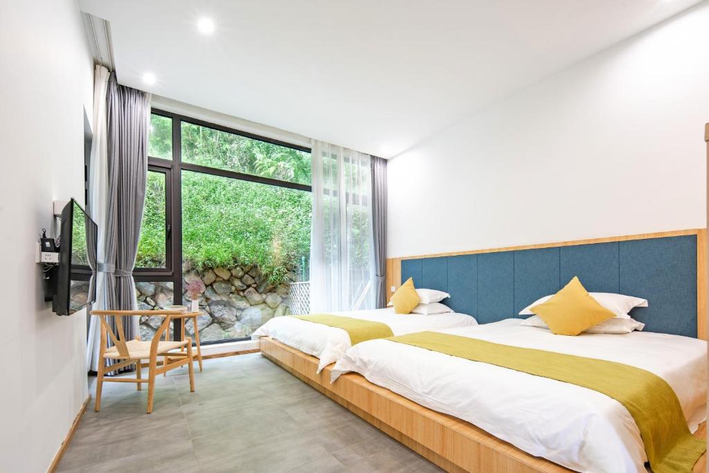 Postel nebo postele na pokoji v ubytování Moganshan Naicang Boutique Hotel
