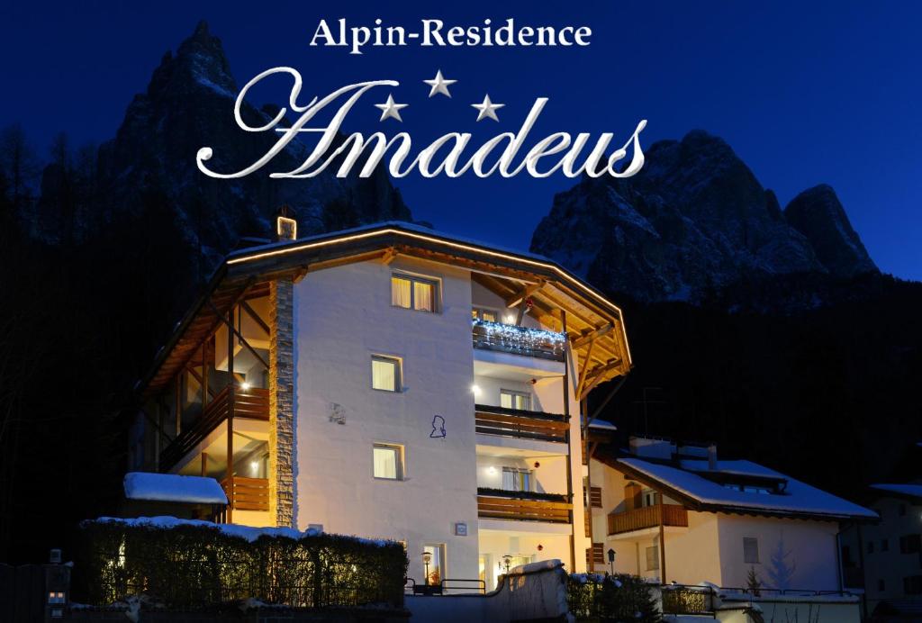 a hotel in the mountains with the words akira residence ambassadors at Alpin-Residence Amadeus in Siusi