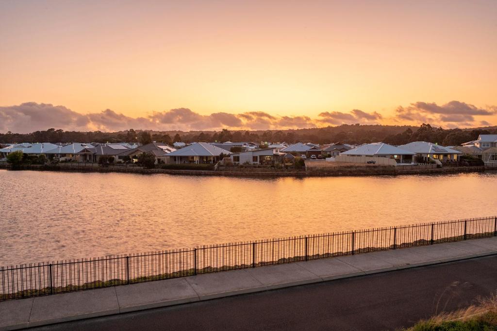 a body of water with houses and a fence at The Lookout in Dunsborough