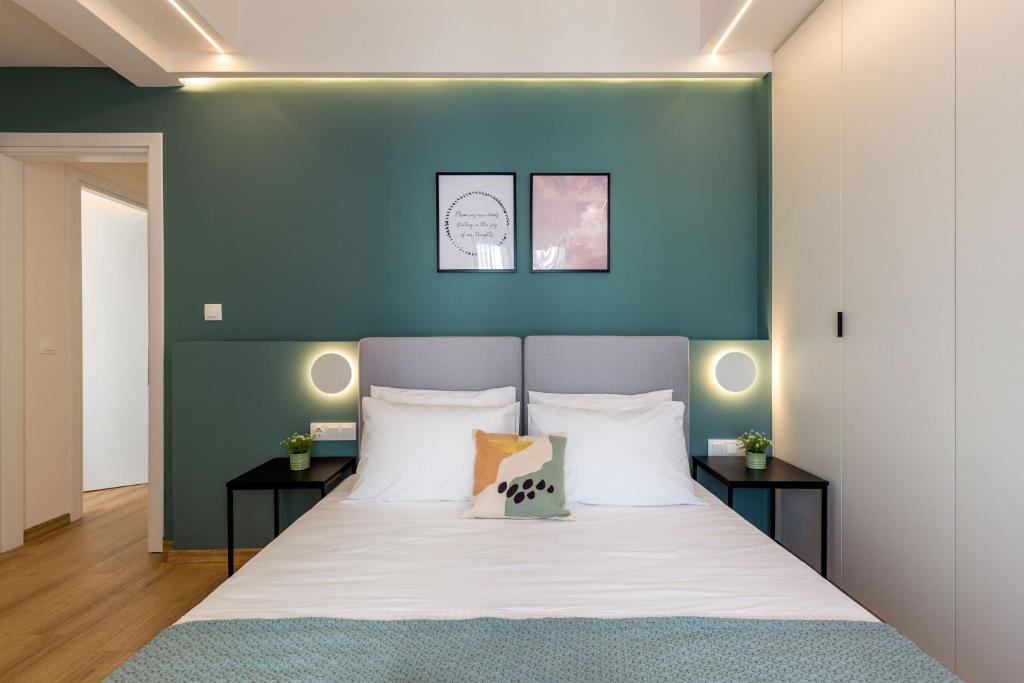 Posteľ alebo postele v izbe v ubytovaní IO SUITES
