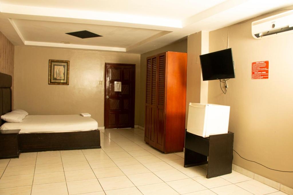 Postel nebo postele na pokoji v ubytování Hotel Queens
