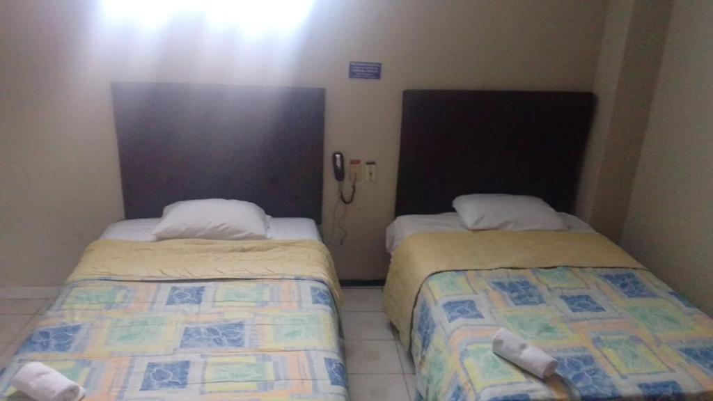 Postel nebo postele na pokoji v ubytování Hotel Queens