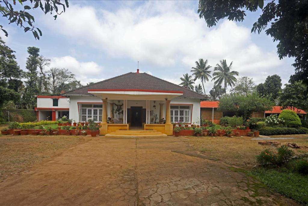 a small house with a driveway leading to it at Devi Villa - Plantation Retreat and Forest Getaway in Kutta