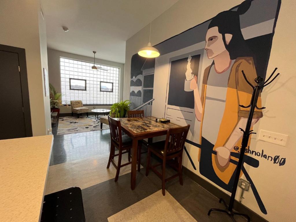 a dining room with a table and a large painting on the wall at Trendy Downtown Apartments in Roanoke