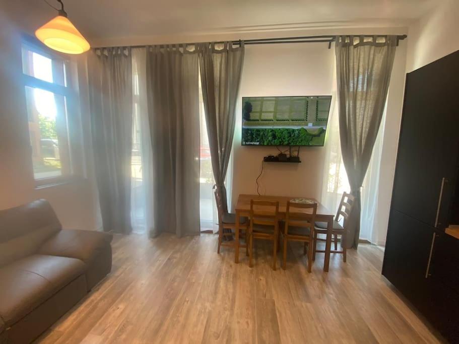 a living room with a table and chairs and a couch at Apartment Vitosha vu Sofia in Sofia
