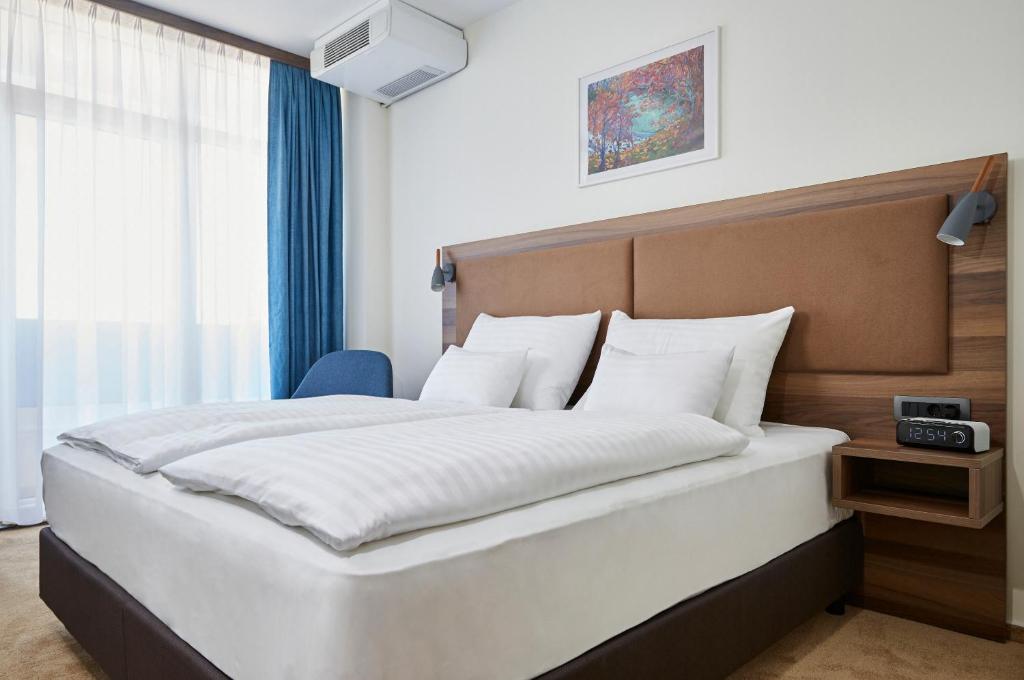 Postel nebo postele na pokoji v ubytování Thermal Resort Hotel Lendava