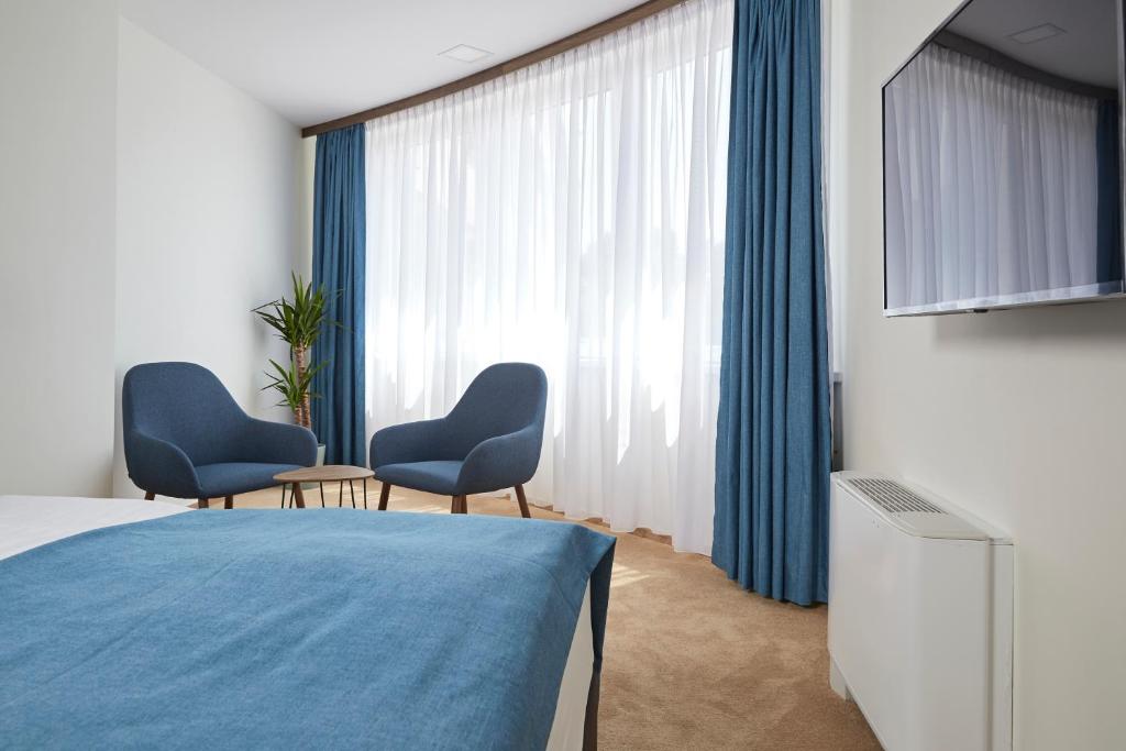 Postel nebo postele na pokoji v ubytování Thermal Resort Hotel Lendava