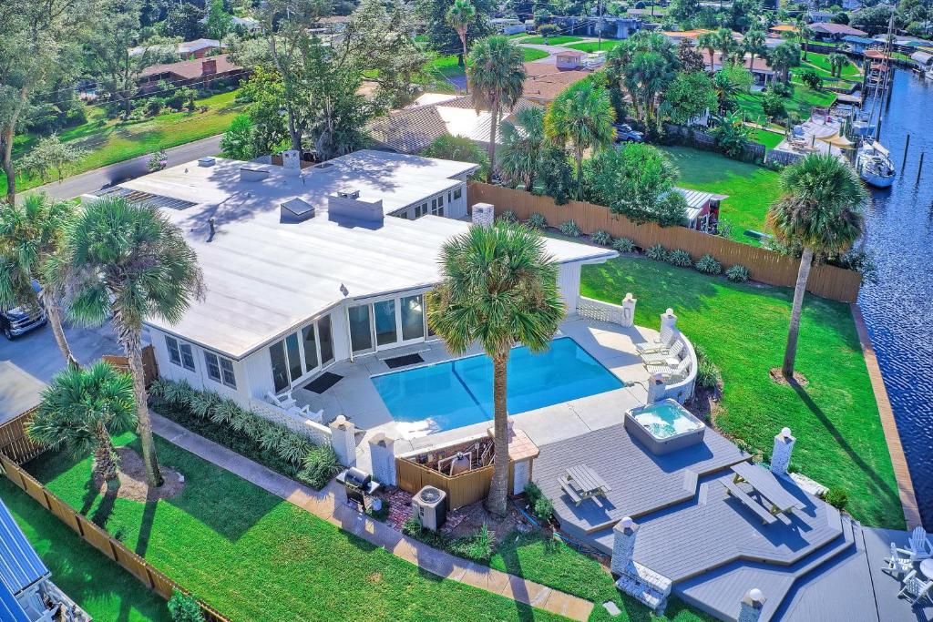 an aerial view of a house with a swimming pool and palm trees at Bay Shore in Panama City Beach