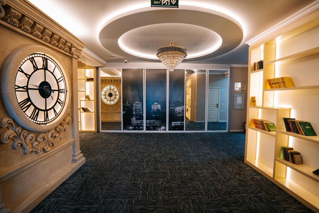a hallway with a large clock on the wall at The Clocktower Hotel in Baku