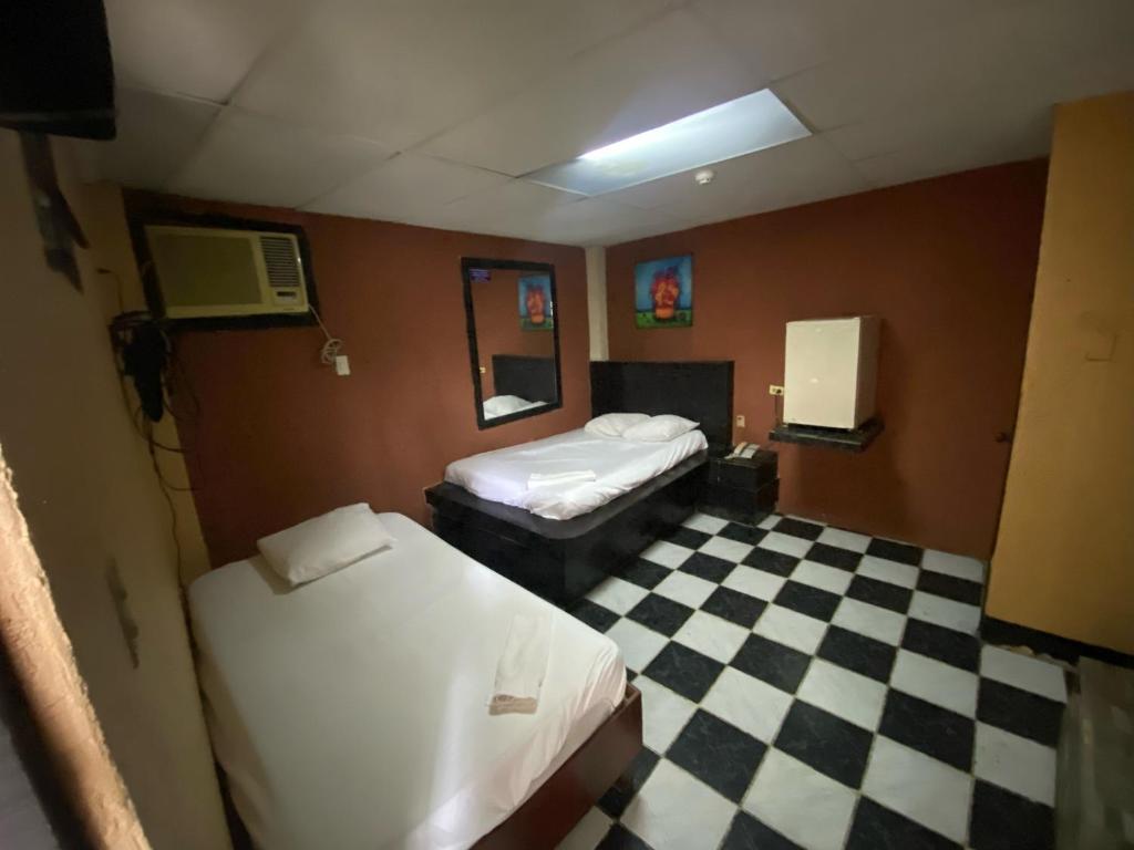 Postel nebo postele na pokoji v ubytování Hotel Imperial