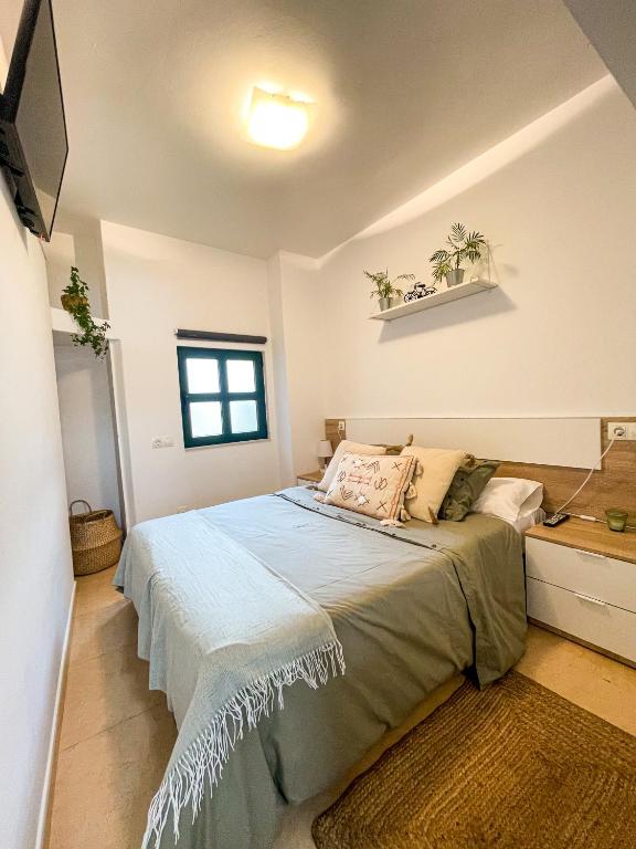 A bed or beds in a room at Apartamentos Sapoconcho by ALÔGA