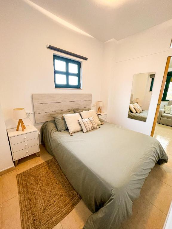 A bed or beds in a room at Apartamentos Sapoconcho by ALÔGA