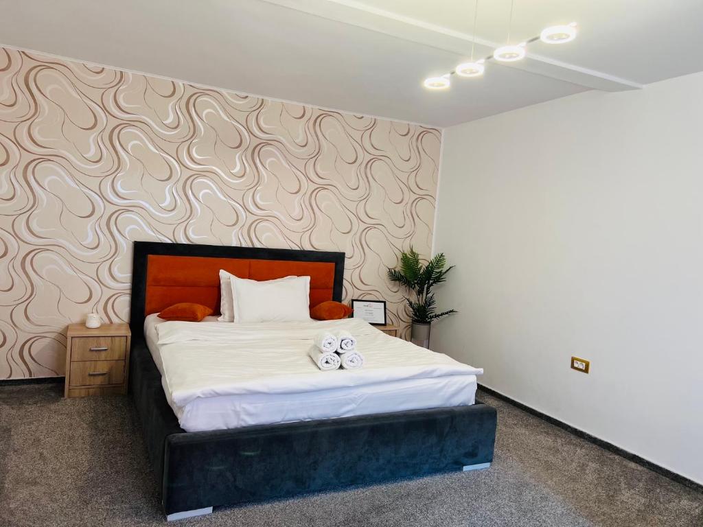 Postel nebo postele na pokoji v ubytování Orange House Constanta