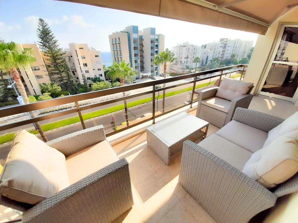 a balcony with furniture and a view of a city at Samson Sea Breeze, 3bed sleeps 6, free WiFi in Limassol