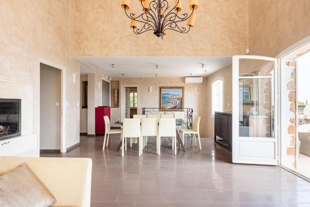 a dining room and kitchen with a table and chairs at VILLA LE MAS D&#39;AZUR BY ESTATESCANNES in Vallauris