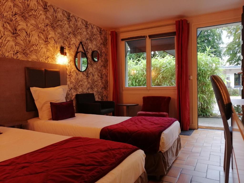 Postel nebo postele na pokoji v ubytování Hôtel Monet