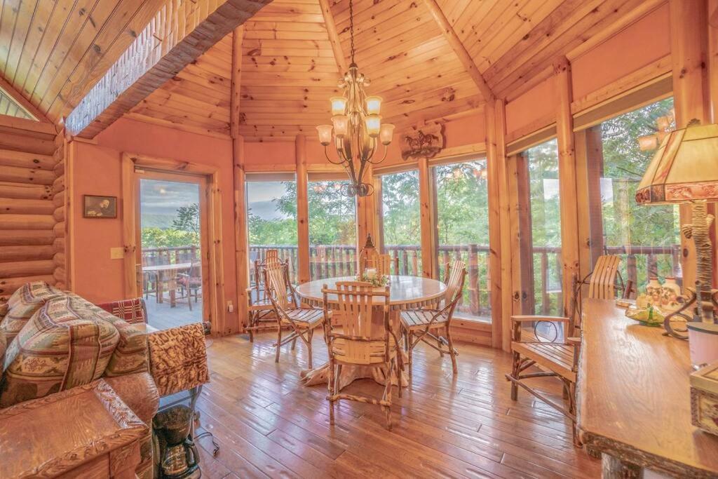 a dining room with a table and chairs at Smoke Rise Lodge · Lake Front, Luxury Cabin, Hot Tub, in Dandridge