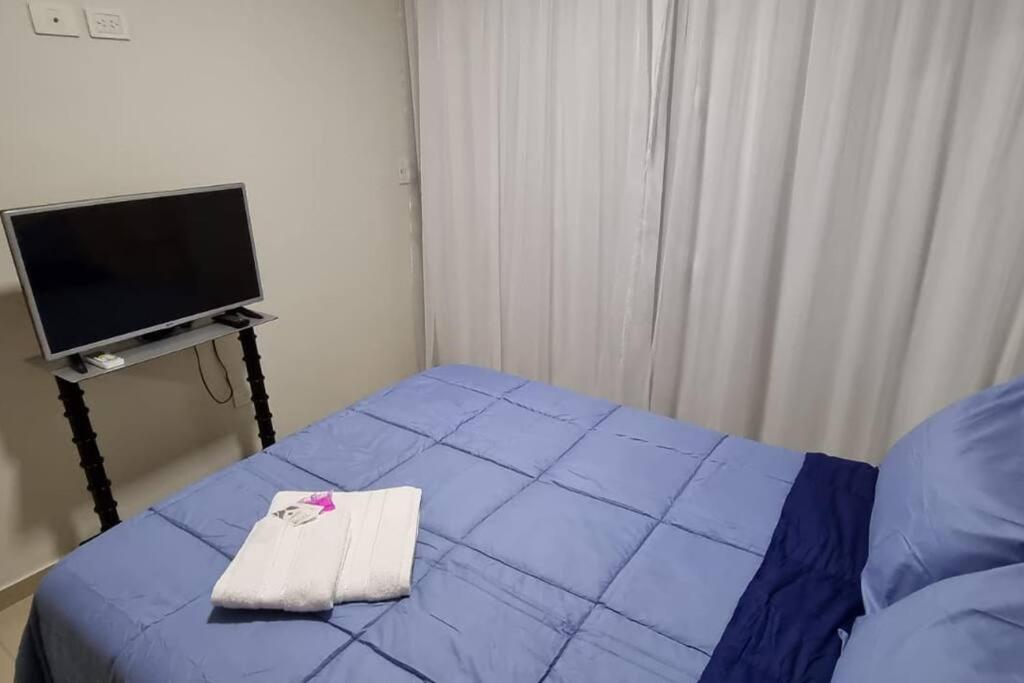 a small bedroom with a bed with a towel on it at Mono Quality - laundry, coworking, pileta y SUM in San Miguel de Tucumán