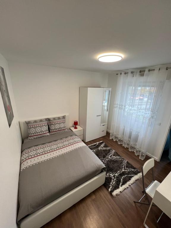 a bedroom with a large bed in a room with curtains at 2 PIECES proche du centre PARIS 15 min in Rosny-sous-Bois