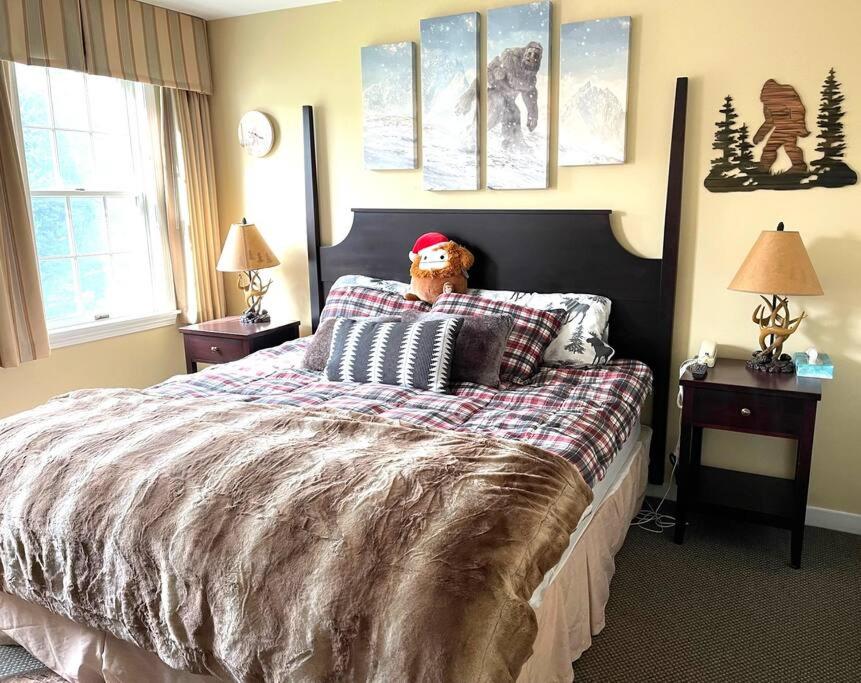 a bedroom with a bed with a teddy bear on it at Unique Yeti-Theme Ski On Off Suite Jiminy-Sleeps 4 in Hancock