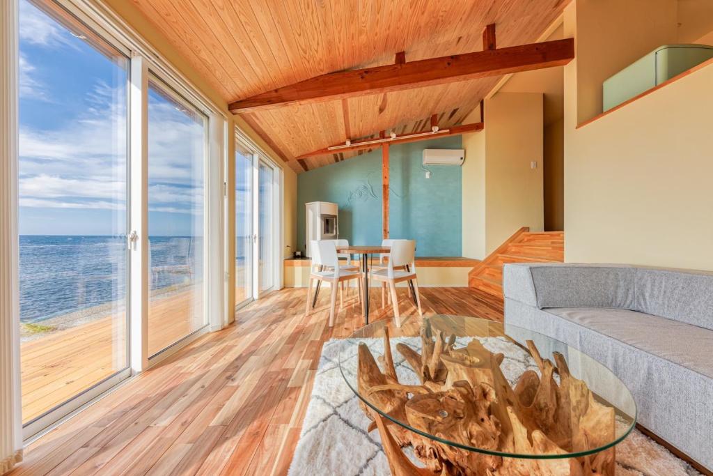 a living room with a view of the ocean at Nihonkai Yuhi Villa One Story - Vacation STAY 67117v 