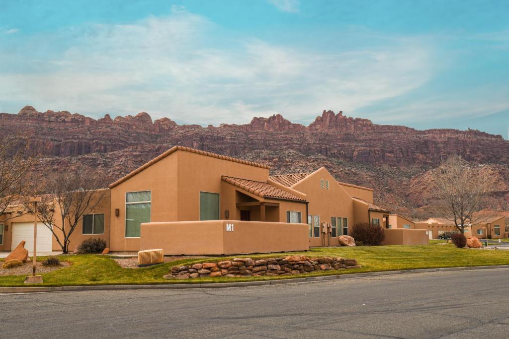 a house with a mountain in the background at Rim Village M4 in Moab