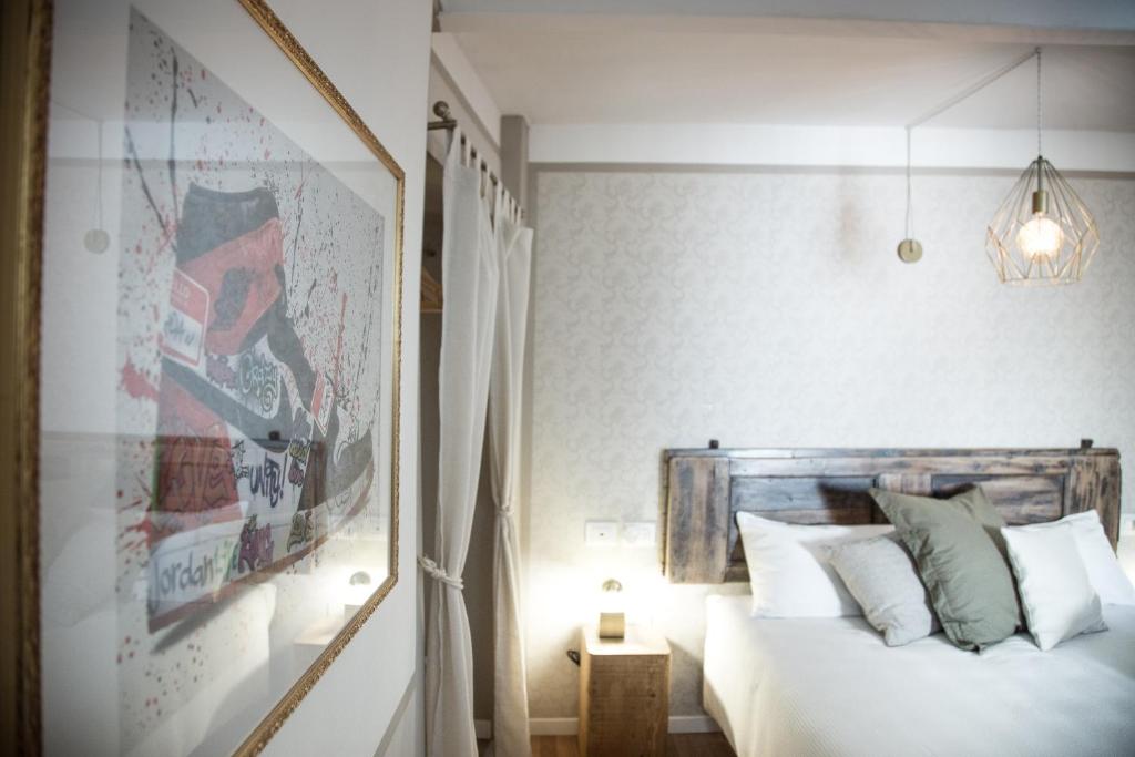 a bedroom with a bed and a mirror at Locanda 53 in Arco