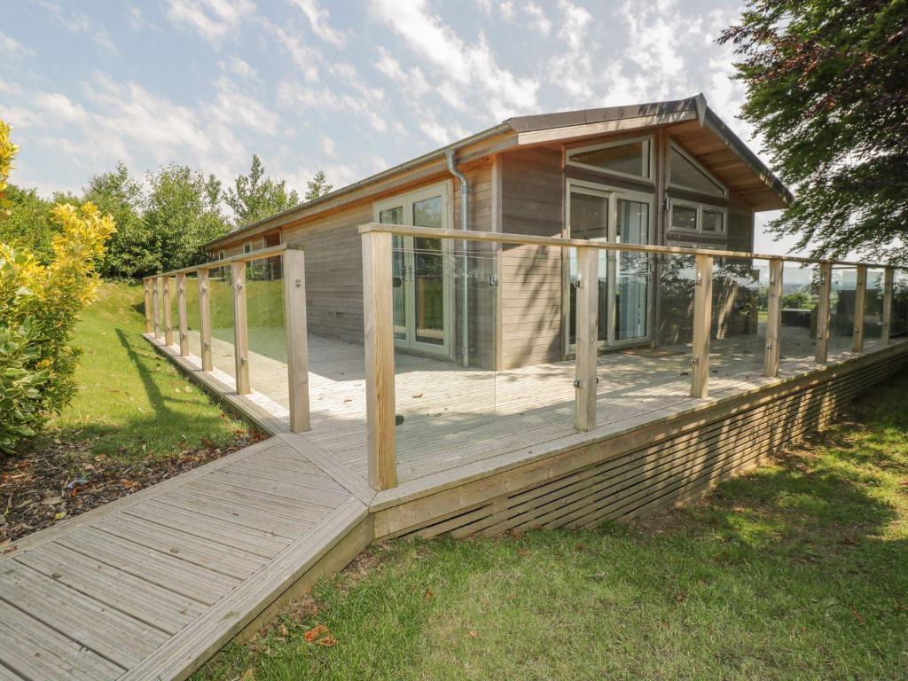 a house with a wooden porch and a deck at 9 Faraway Fields in Liskeard