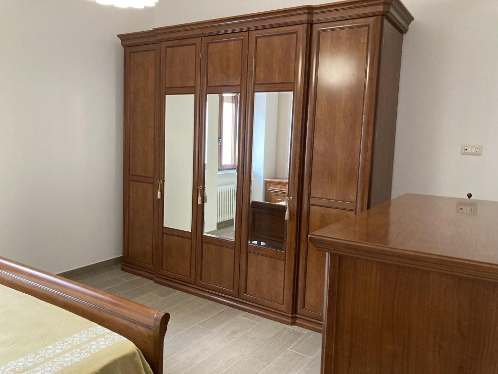 a bedroom with a large wooden cabinet and a bed at Dimora storica don Michele in Castelpagano