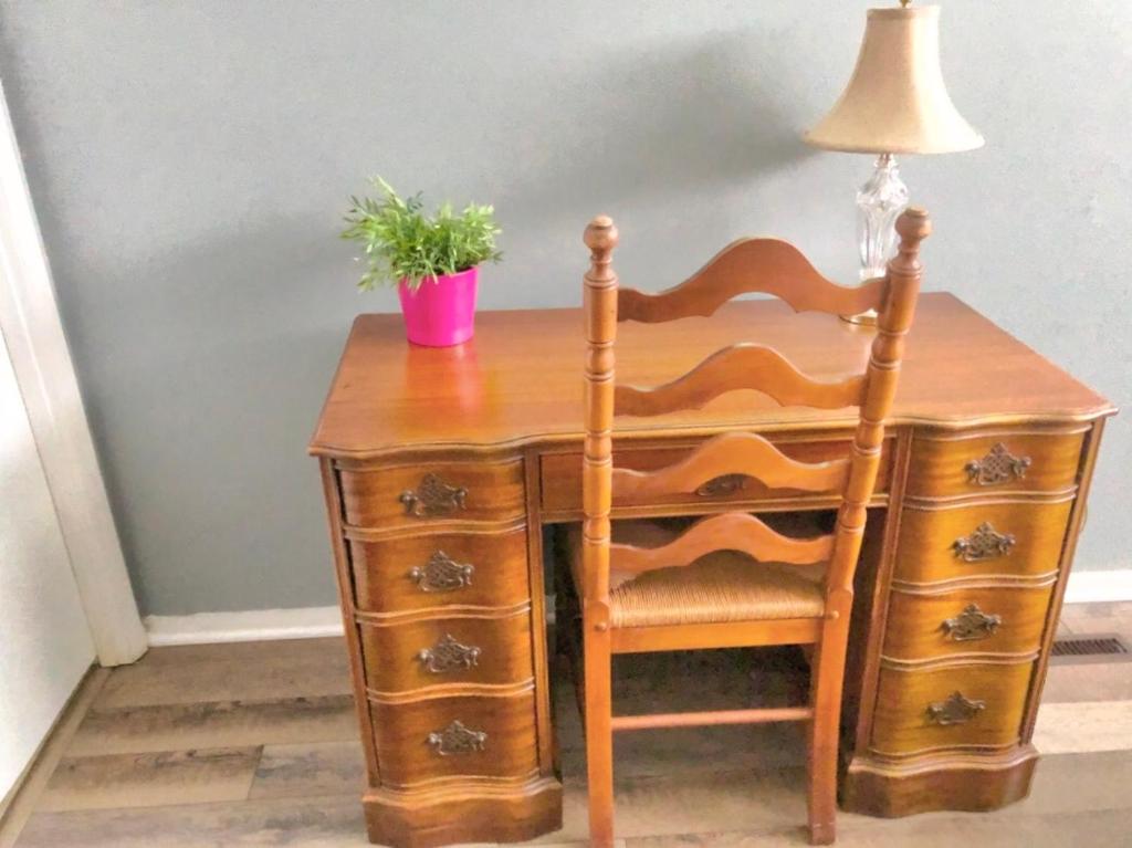 a wooden desk with a lamp and a potted plant at Cheerful 3-BR home near Downtown Dayton, Wright Patterson AFB and Airport in Dayton