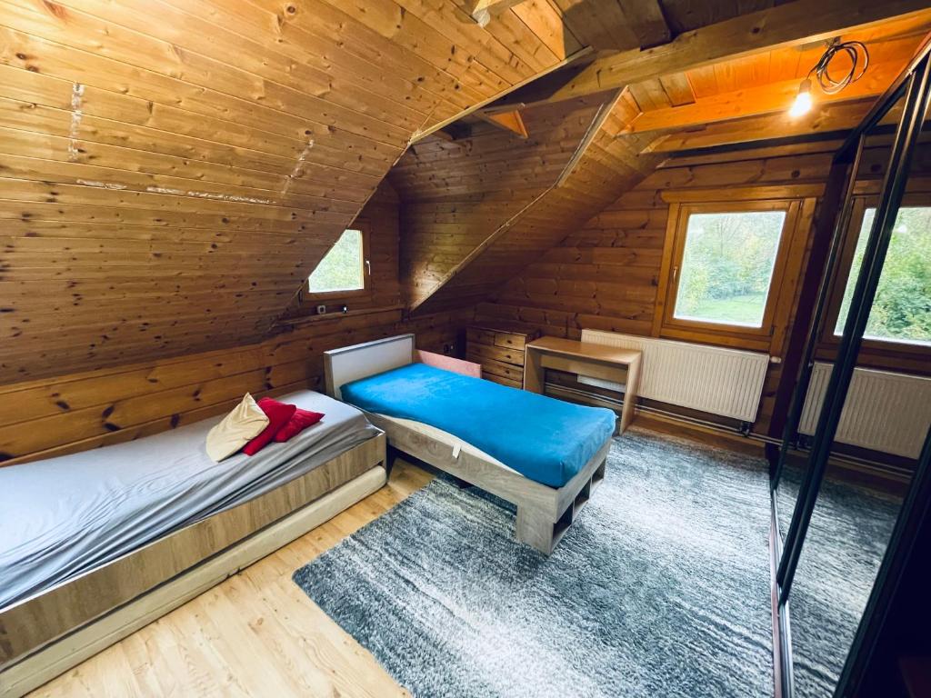 a bedroom with two beds in a wooden cabin at Tantra klub - private room in a shared wooden house in Prague