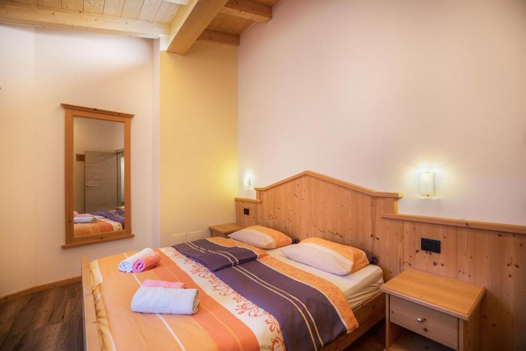 Posteľ alebo postele v izbe v ubytovaní Chalet Osmar Appartamento 2