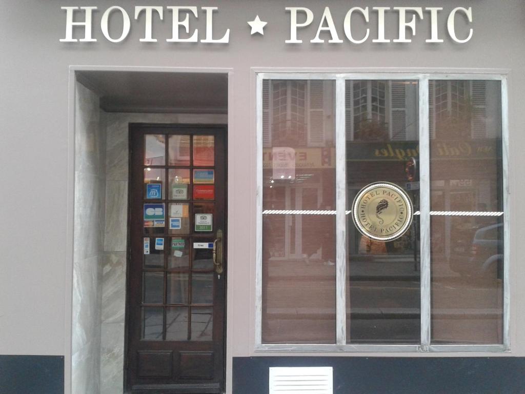 
a store window with a sign on it at Hotel Pacific in Paris
