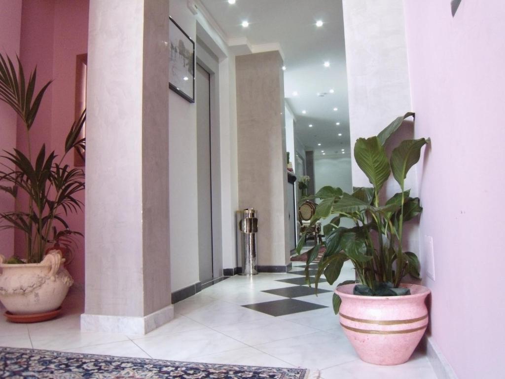 a hallway with potted plants in a building at Hotel Scilla in Scilla