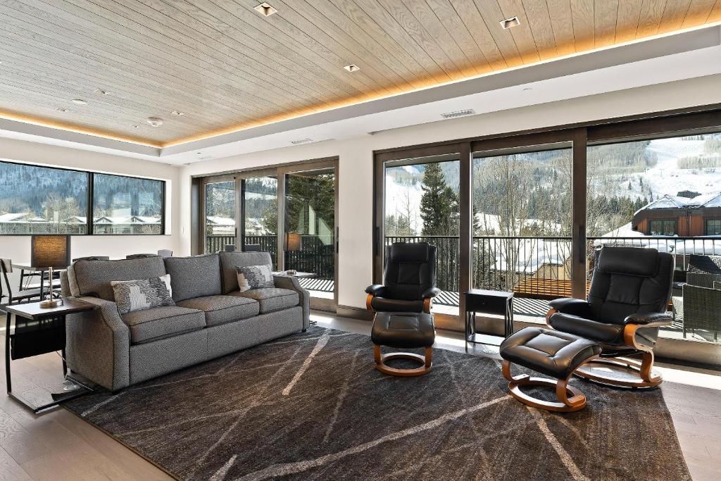 a living room with a couch and two chairs at Altus #206 in Vail