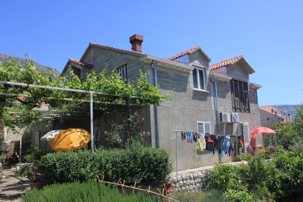 a house with clothes hanging on the side of it at Apartments and rooms with parking space Srebreno, Dubrovnik - 8959 in Mlini