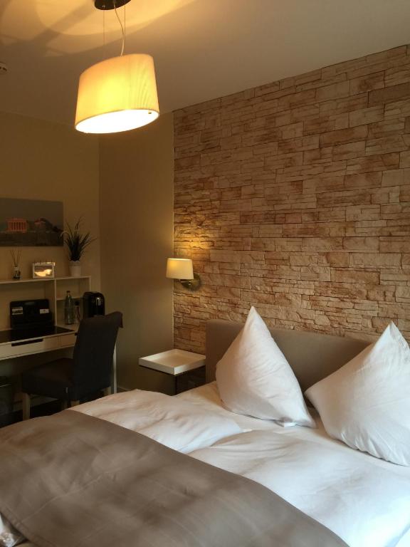 Postel nebo postele na pokoji v ubytování Hotel Achilles