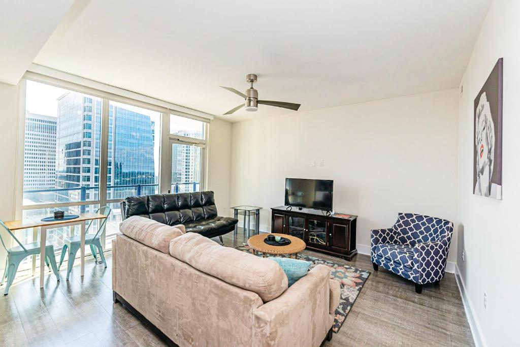 a living room with a couch and a table at 1BR Uptown Charlotte Furnished Apartments apts in Charlotte