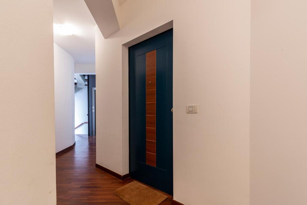 a black door in a hallway with white walls at Apartment Holiday Senigallia in Senigallia